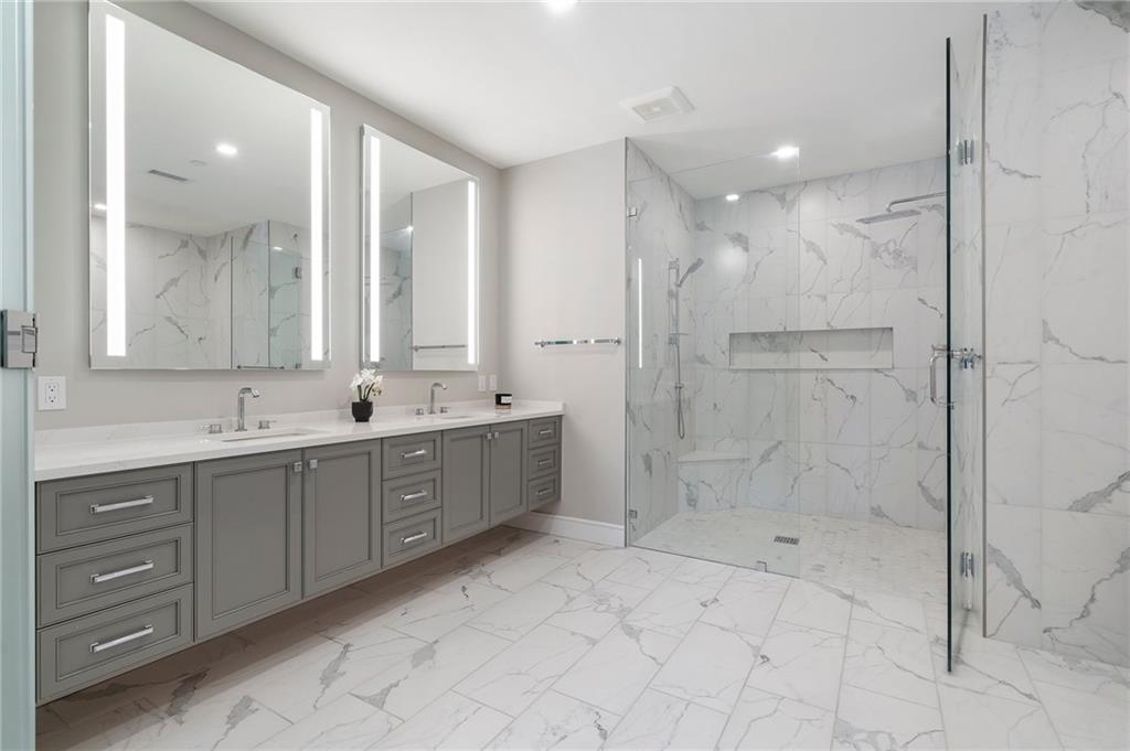 2520 Peachtree Road Northwest, Unit 403 Atlanta, GA 30305 - Photo 26 of 52 a spacious bathroom with a shower sink and mirror