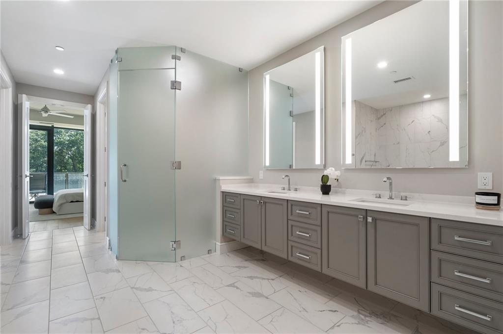 2520 Peachtree Road Northwest, Unit 403 Atlanta, GA 30305 - Photo 29 of 52 a spacious bathroom with a double vanity sink a mirror and a shower
