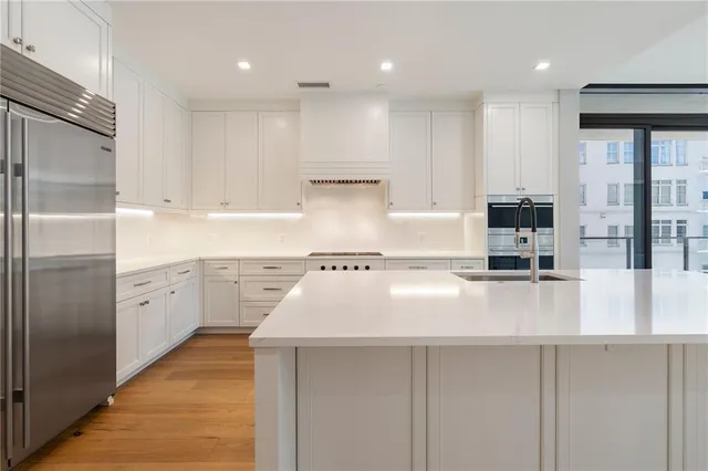 a kitchen with kitchen island granite countertop a sink counter top space stainless steel appliances and cabinets