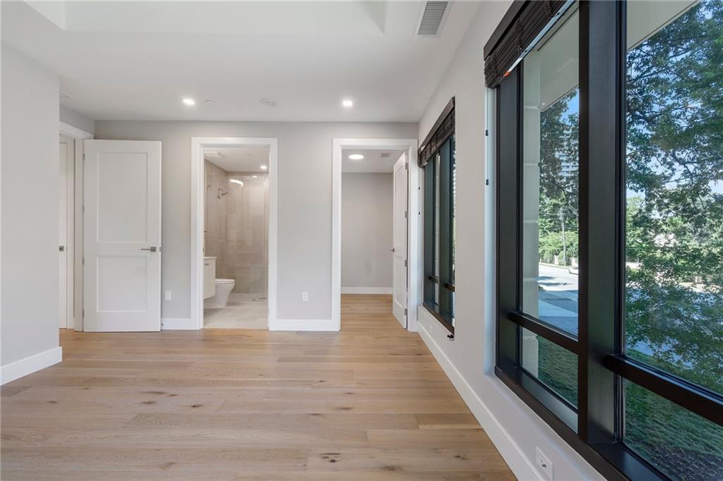 2520 Peachtree Road Northwest, Unit 403 Atlanta, GA 30305 - Photo 32 of 52 a view of a hallway with wooden floor and door