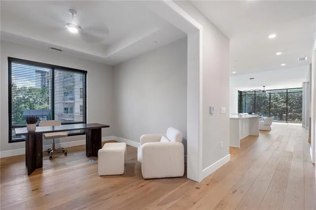 a utility room with stainless steel appliances white cabinets and a sink