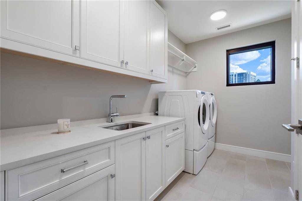 2520 Peachtree Road Northwest, Unit 403 Atlanta, GA 30305 - Photo 37 of 52 a utility room with stainless steel appliances white cabinets and a sink