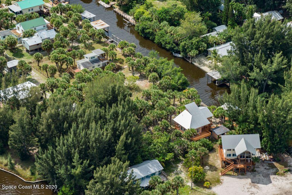 48 Vip Island, Unit B Grant, FL 32949 - Photo 7 of 9 an aerial view of a house with a yard and lake view
