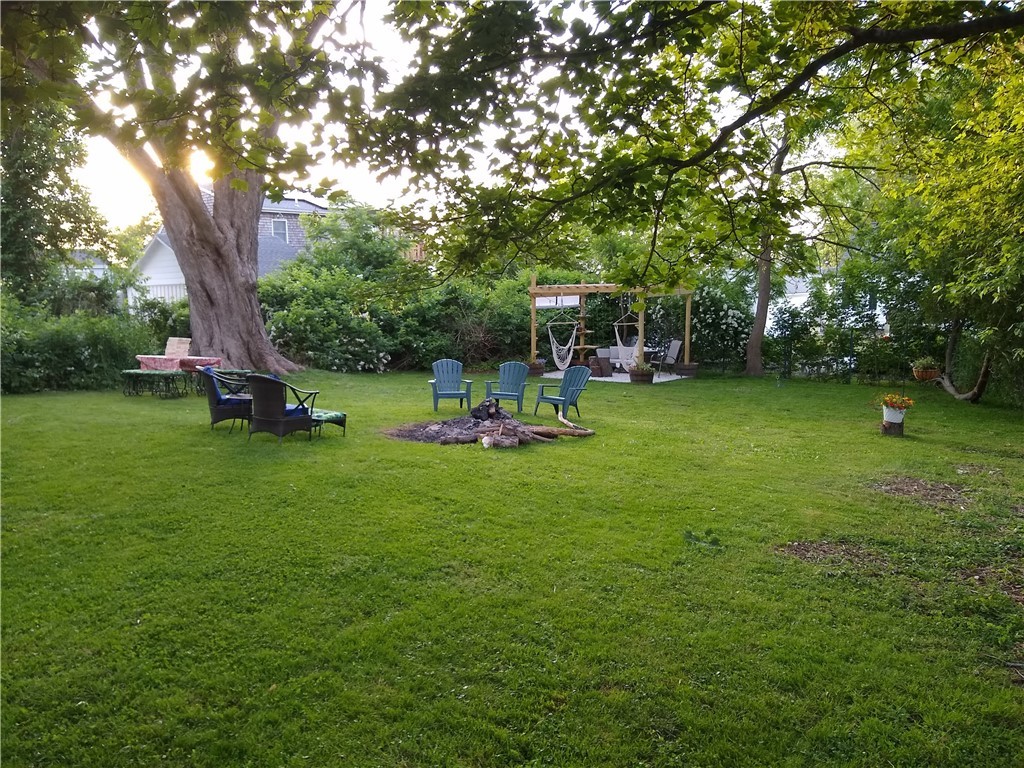 93 Maple Avenue Middletown, RI 02842 - Photo 3 of 29 Large wooded back yard with pergola and fire pit