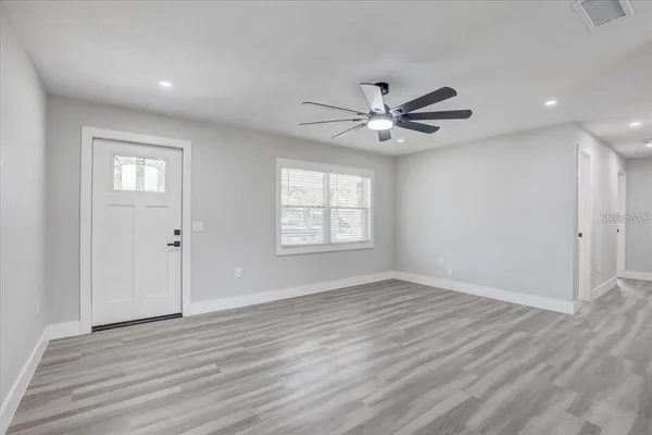 wooden floor in an empty room with a window