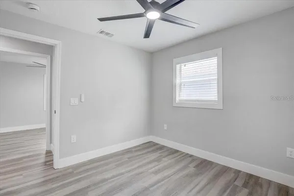 wooden floor in an empty room with a window