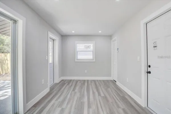 a view of a room with wooden floor and window