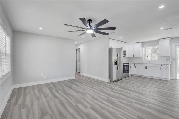 a view of a kitchen with wooden floor and a kitchen
