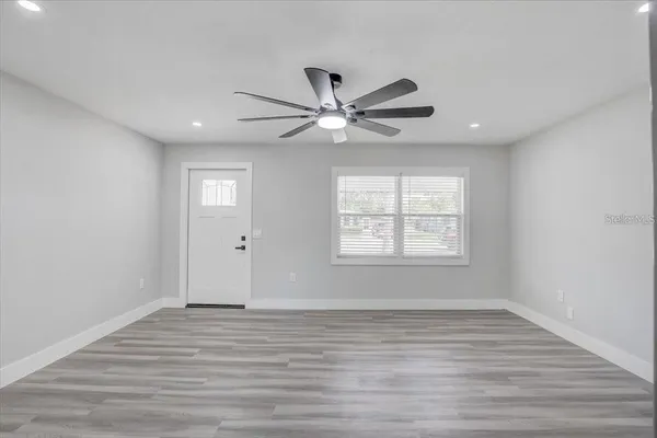 wooden floor in an empty room with a window