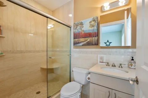 a bathroom with a sink toilet and shower