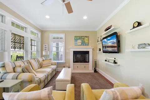 a living room with furniture fireplace and flat screen tv