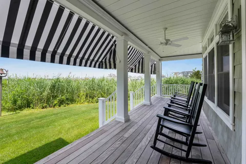 a view of a porch with furniture and garden