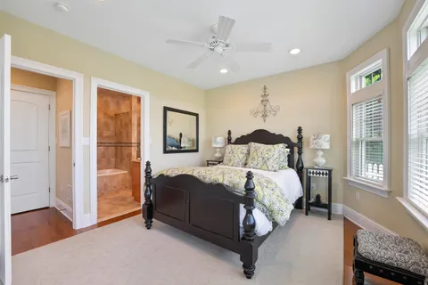 a spacious bedroom with a bed and a chandelier