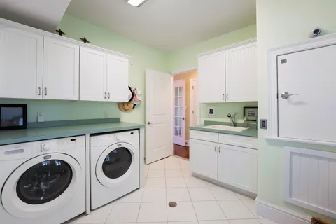 a utility room with sink dryer and washer