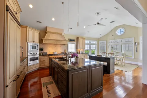 a kitchen with stainless steel appliances granite countertop a stove and refrigerator