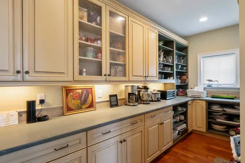 a kitchen with stainless steel appliances granite countertop a sink a stove and cabinets
