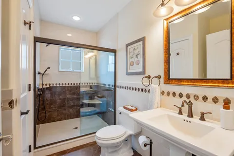 a bathroom with a sink toilet and shower