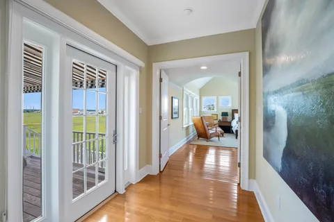 a view of a hallway view with living room and wooden floor