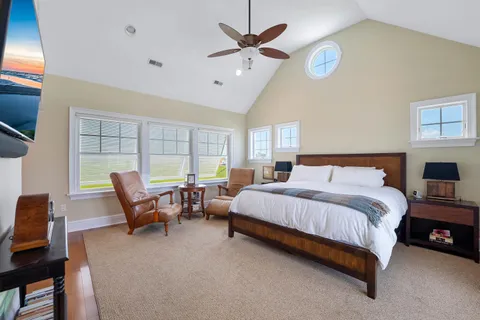 a spacious bathroom with a granite countertop sink toilet a mirror and a bathtub