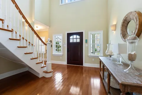 a view of a livingroom with furniture stairs and wooden floor
