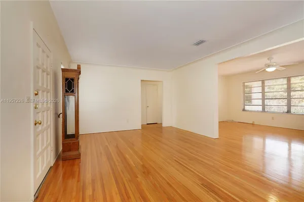 wooden floor in an empty room with a window