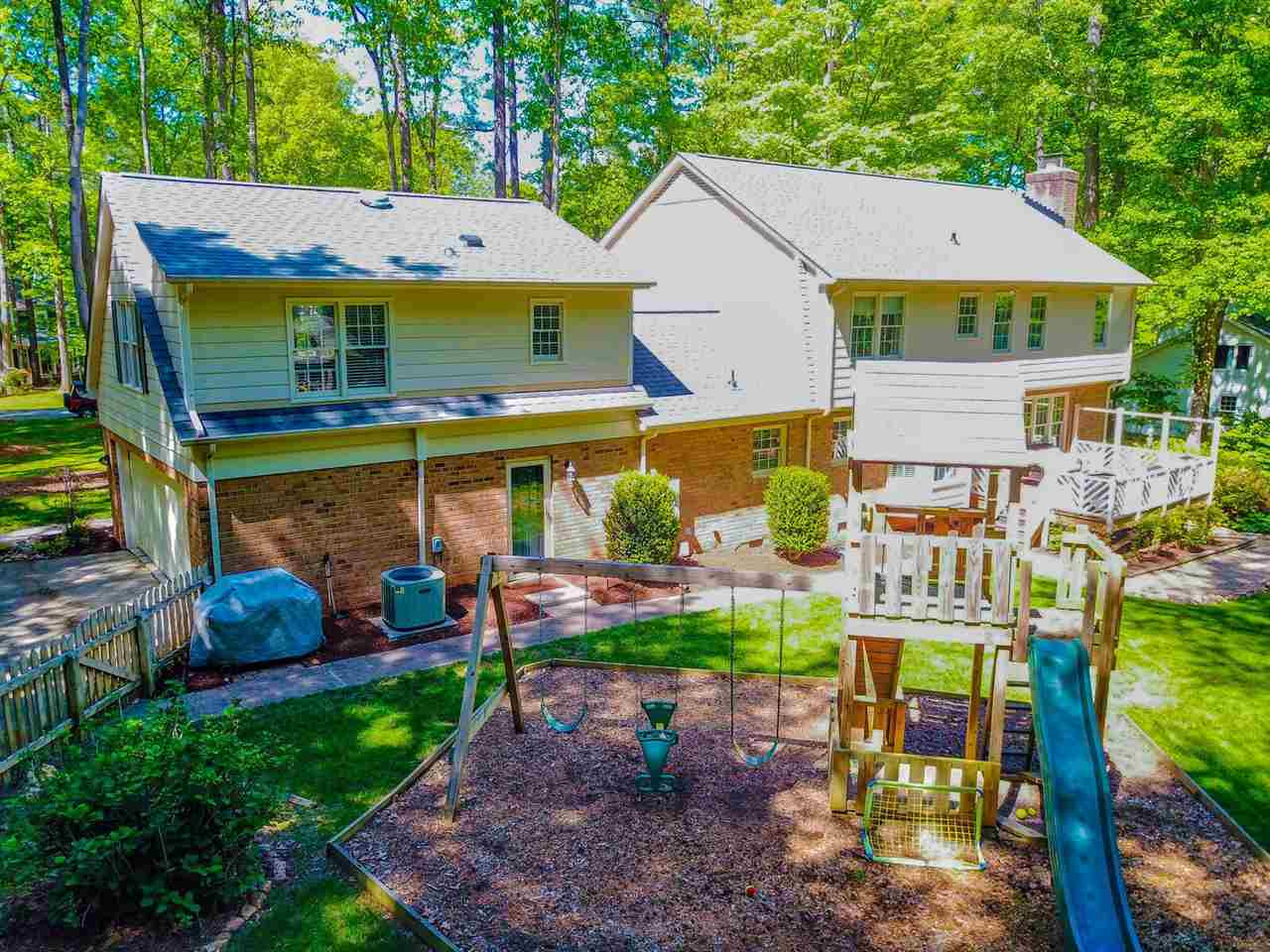 10016 Bushveld Lane Raleigh, NC 27613 - Photo 3 of 24 What a great backyard! Spacious deck, children's play area, fire pit, and custom pebble path linking it all together. Exterior Back