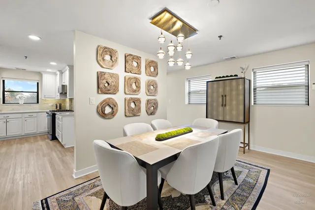 a kitchen with a sink cabinets and wooden floor