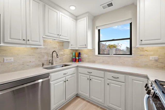 a kitchen with stainless steel appliances a refrigerator sink and stove