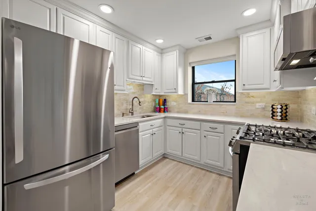 a kitchen with stainless steel appliances a stove a microwave and cabinets