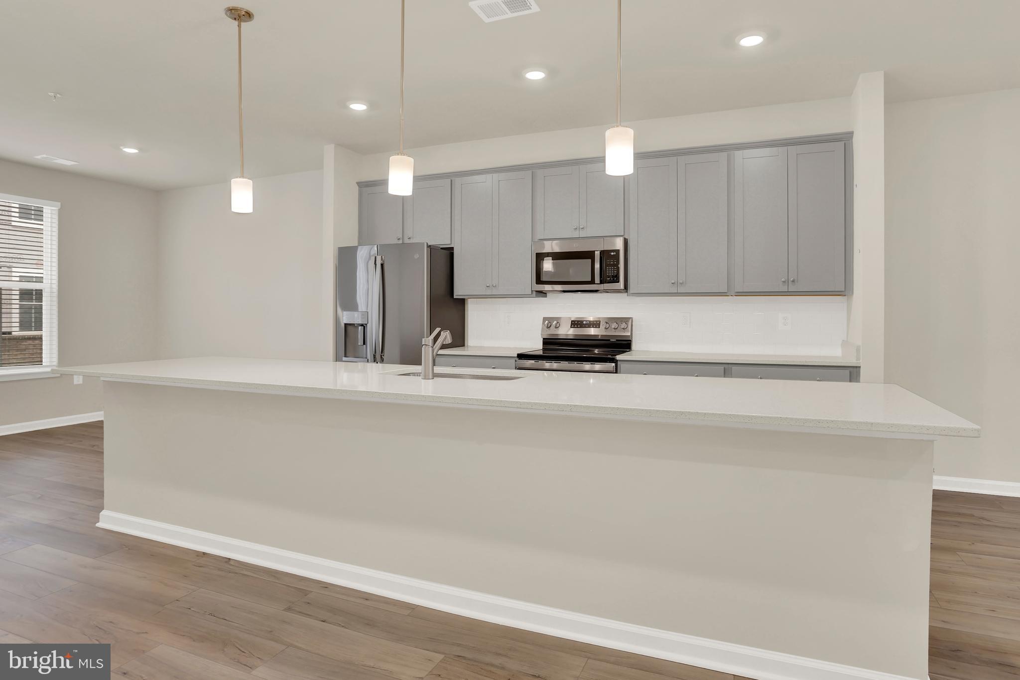 9666 Swallowtail Lane Manassas, VA 20110 - Photo 17 of 92 a kitchen with kitchen island a sink stainless steel appliances and cabinets