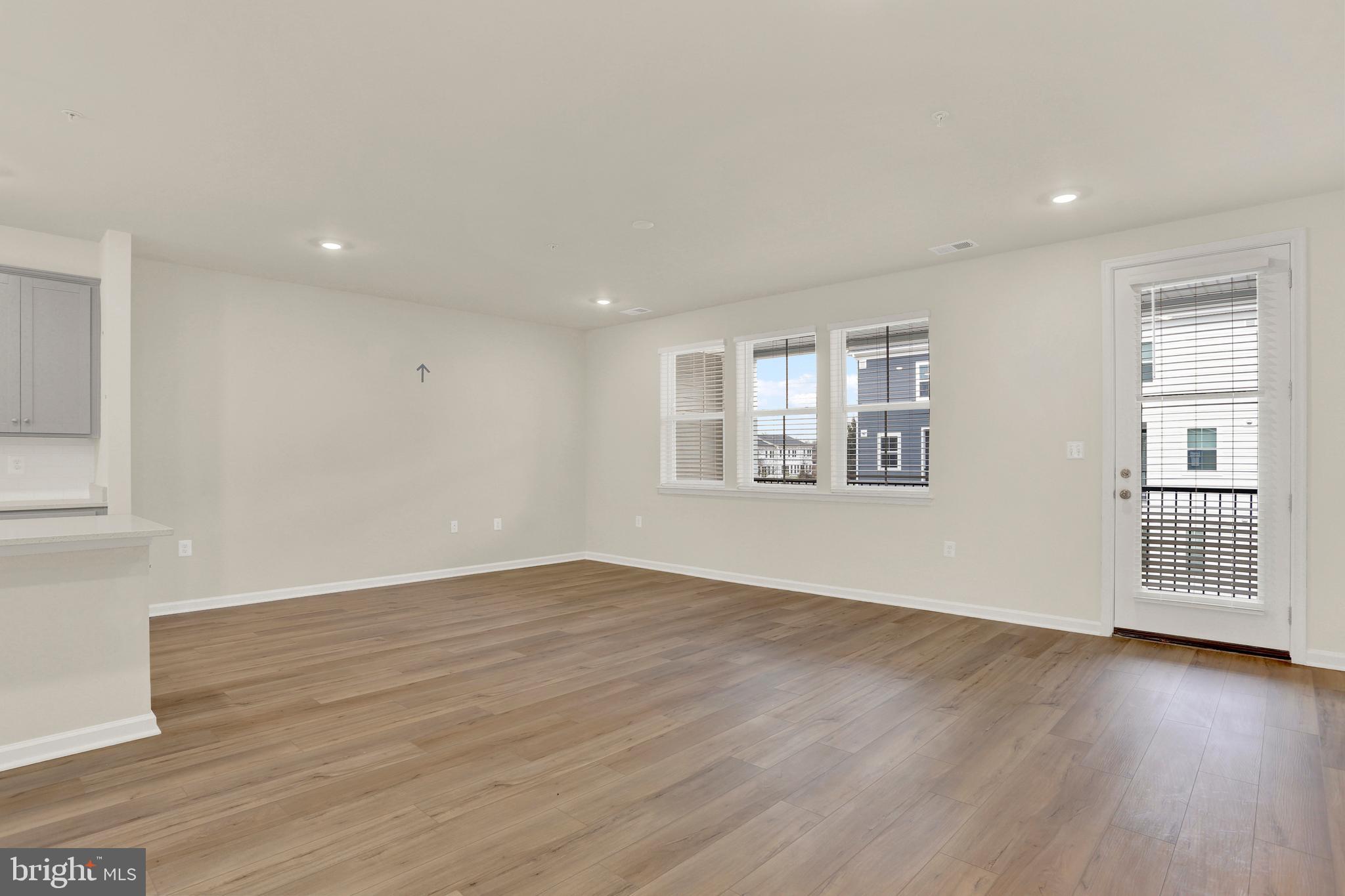 9666 Swallowtail Lane Manassas, VA 20110 - Photo 21 of 92 a view of an empty room with wooden floor and a window