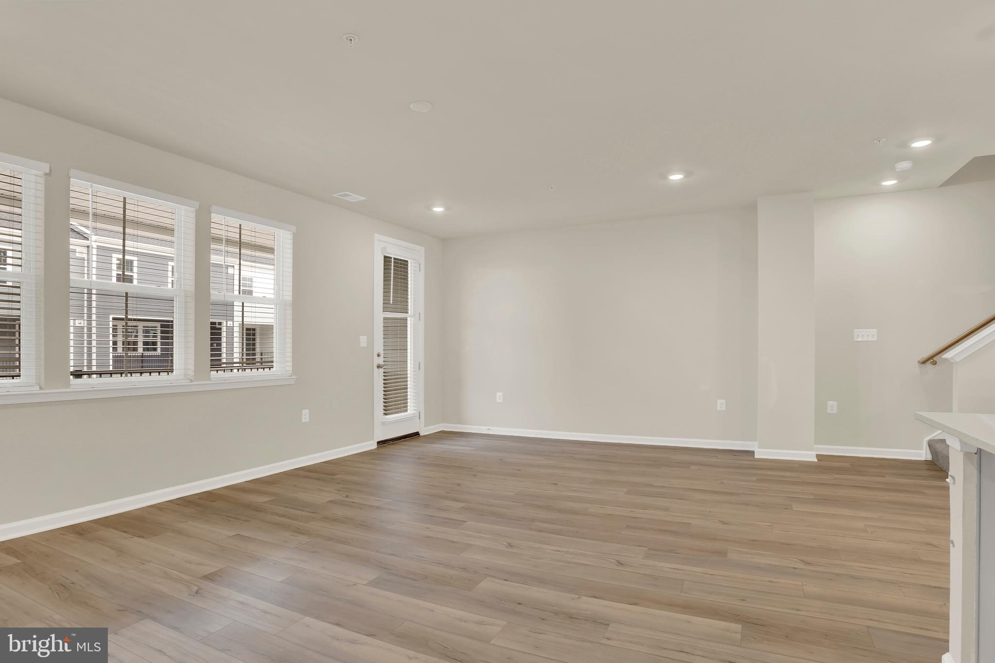 9666 Swallowtail Lane Manassas, VA 20110 - Photo 26 of 92 a view of an empty room with wooden floor and a window