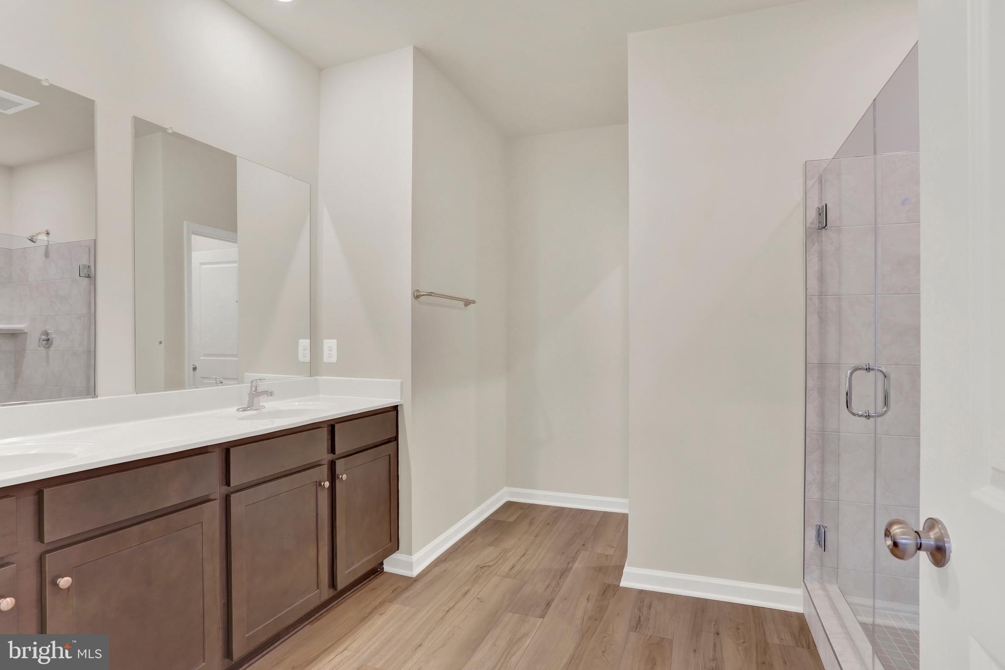 9666 Swallowtail Lane Manassas, VA 20110 - Photo 35 of 92 a bathroom with a sink a mirror and a shower