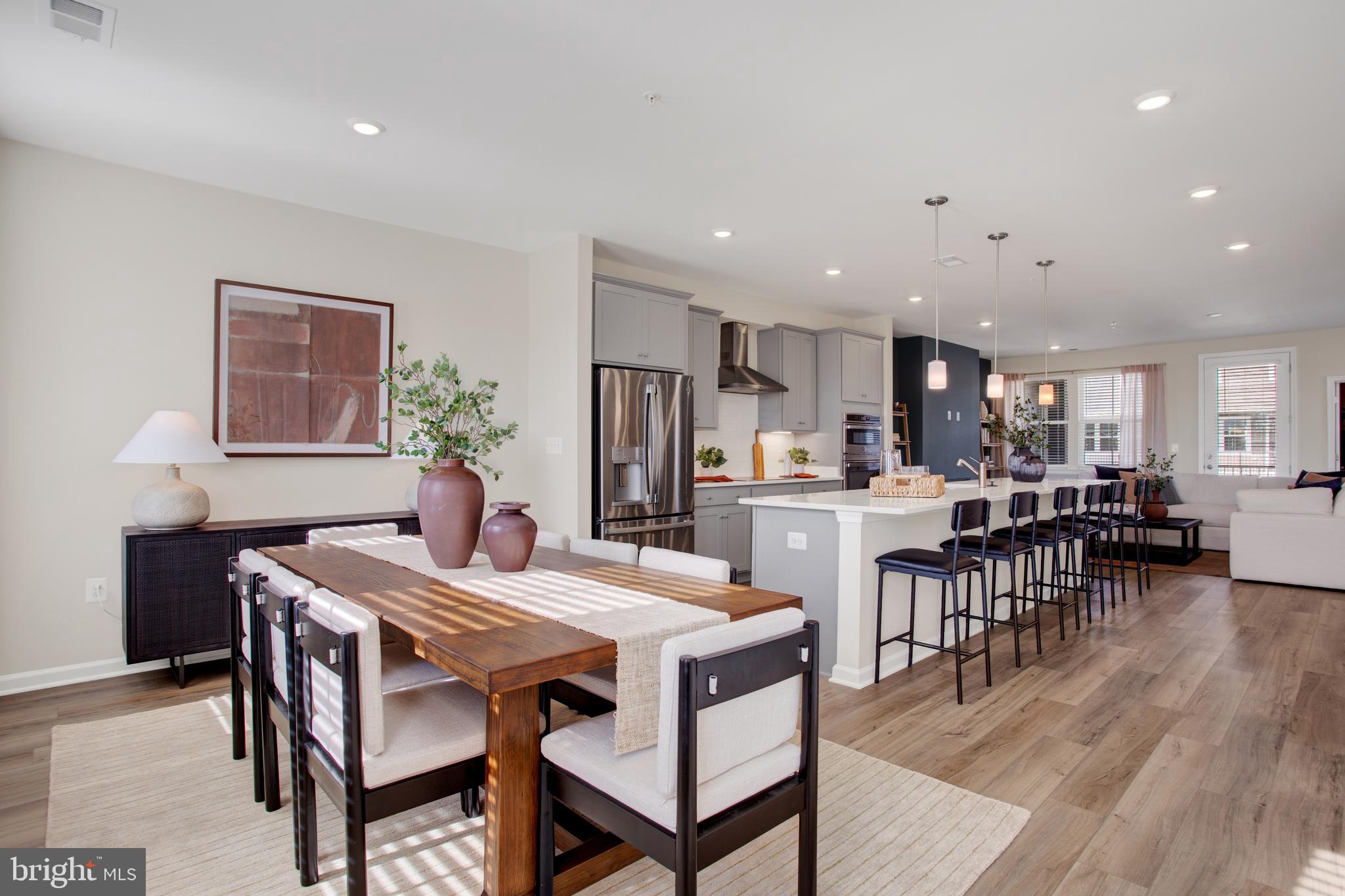 9666 Swallowtail Lane Manassas, VA 20110 - Photo 4 of 92 a view of a dining room with furniture and wooden floor