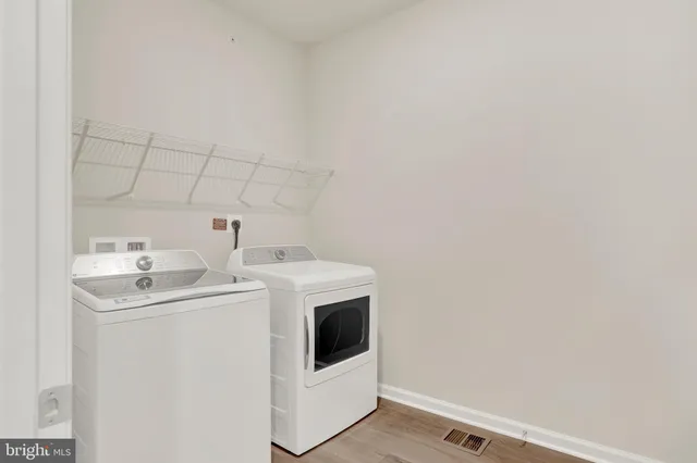 a view of the patio with a table and chairs and potted plants