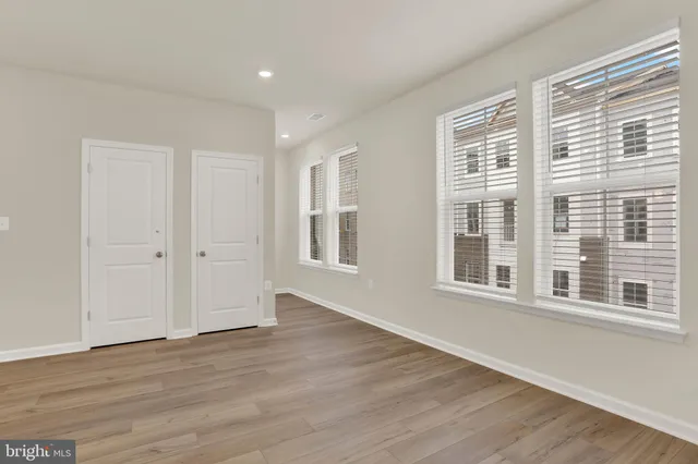 a large white kitchen with lots of counter space a sink appliances and cabinets