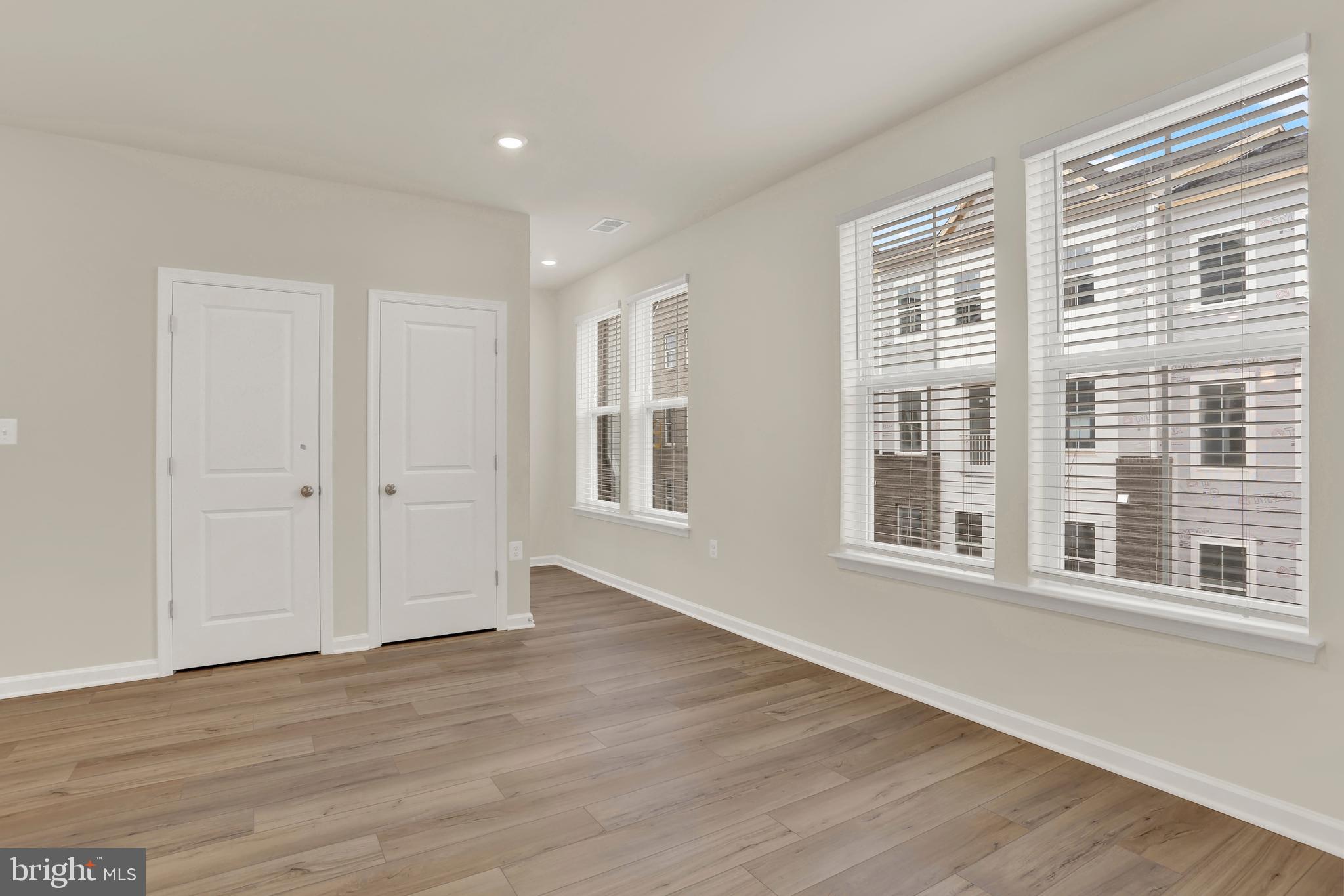 9666 Swallowtail Lane Manassas, VA 20110 - Photo 6 of 92 a view of an empty room with wooden floor and windows