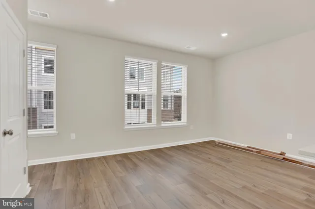 a kitchen with stainless steel appliances granite countertop white cabinets a refrigerator and a stove