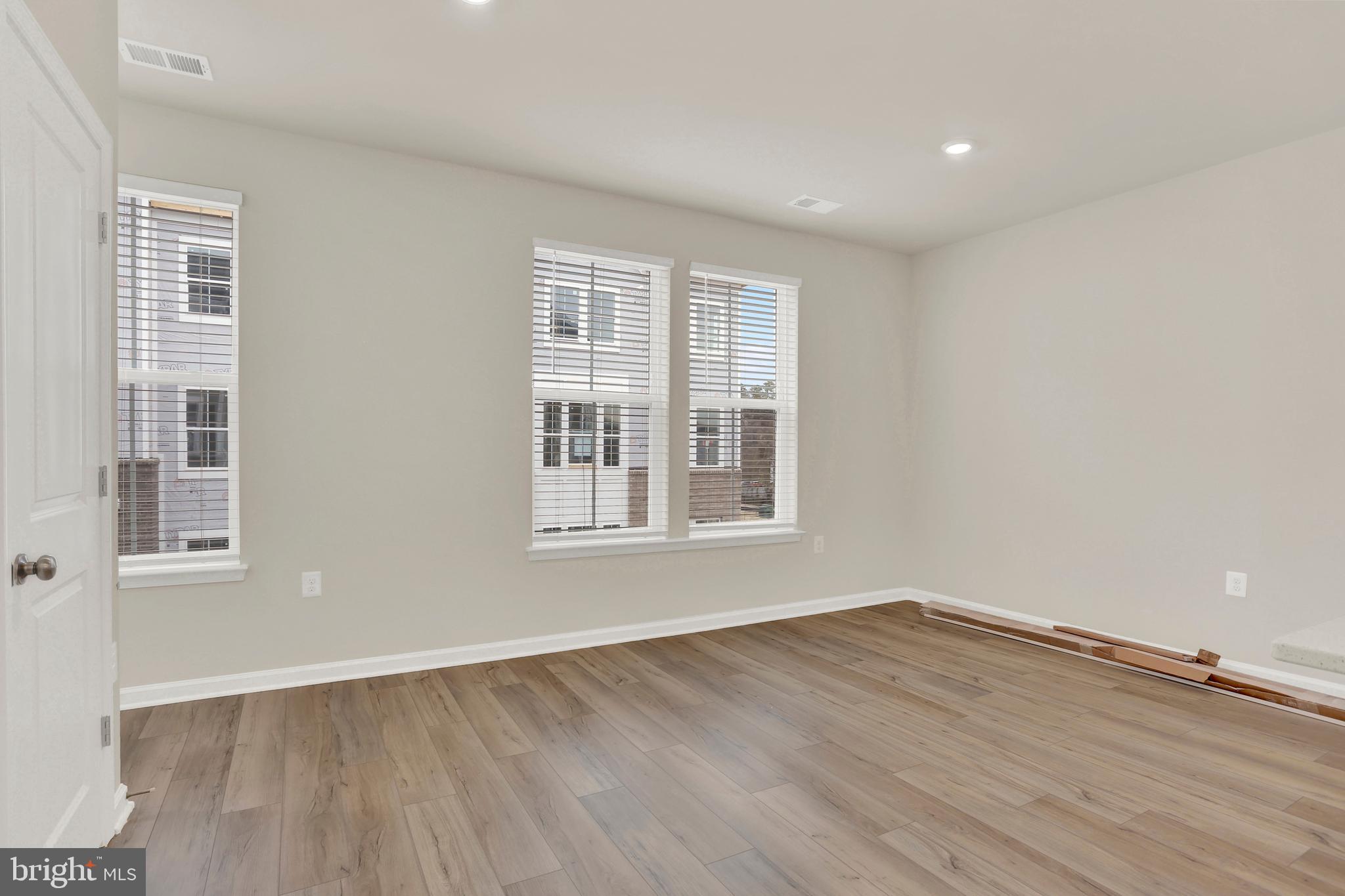 9666 Swallowtail Lane Manassas, VA 20110 - Photo 8 of 92 a view of an empty room with wooden floor and a window