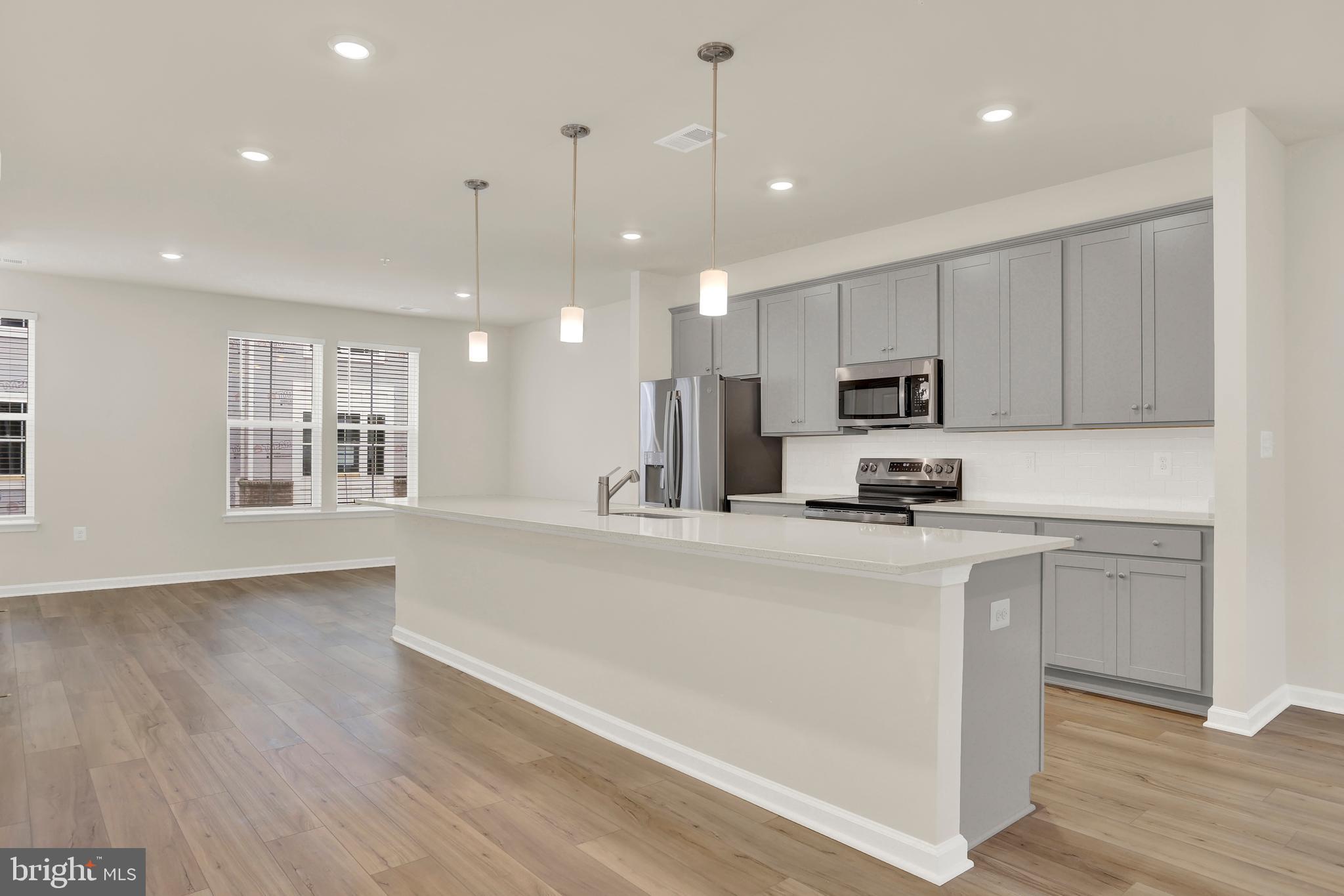 9666 Swallowtail Lane Manassas, VA 20110 - Photo 10 of 92 a large white kitchen with lots of counter space a sink appliances and cabinets