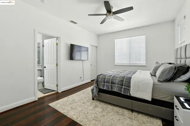 a bedroom with a bed tv and a window