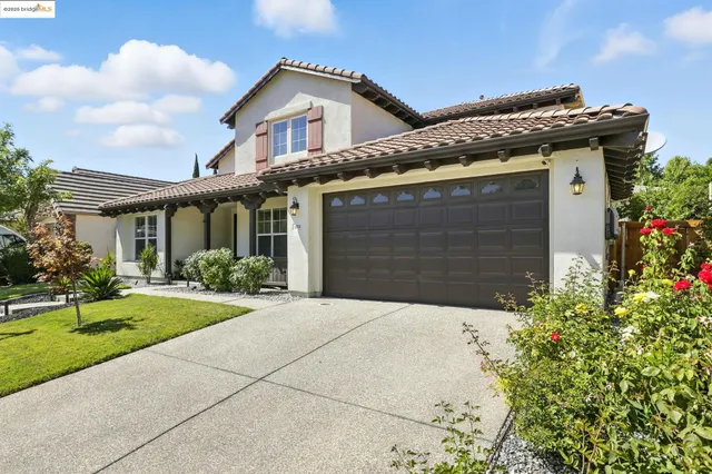 a bunch of flowers in front of house