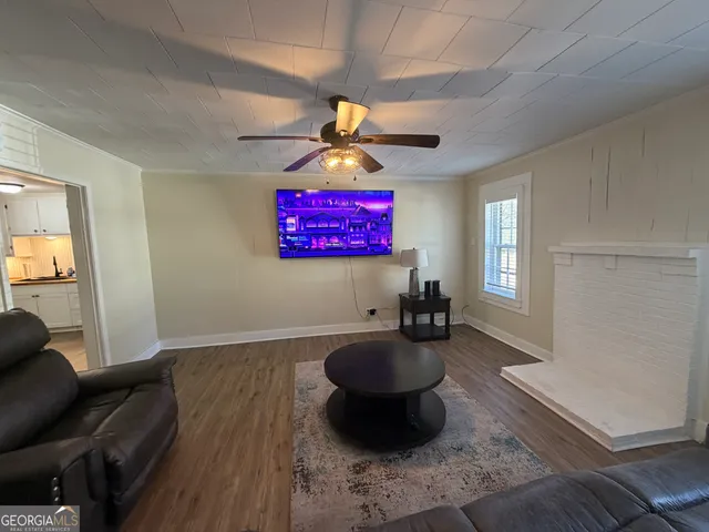 a kitchen with granite countertop a refrigerator oven a sink dishwasher and a stove with wooden floor