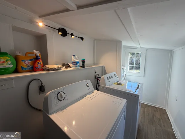 a view of a house with a yard and large trees