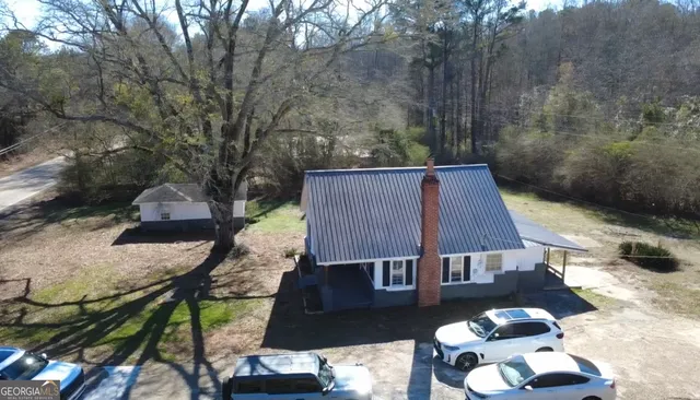 a backyard of a house with table and chairs