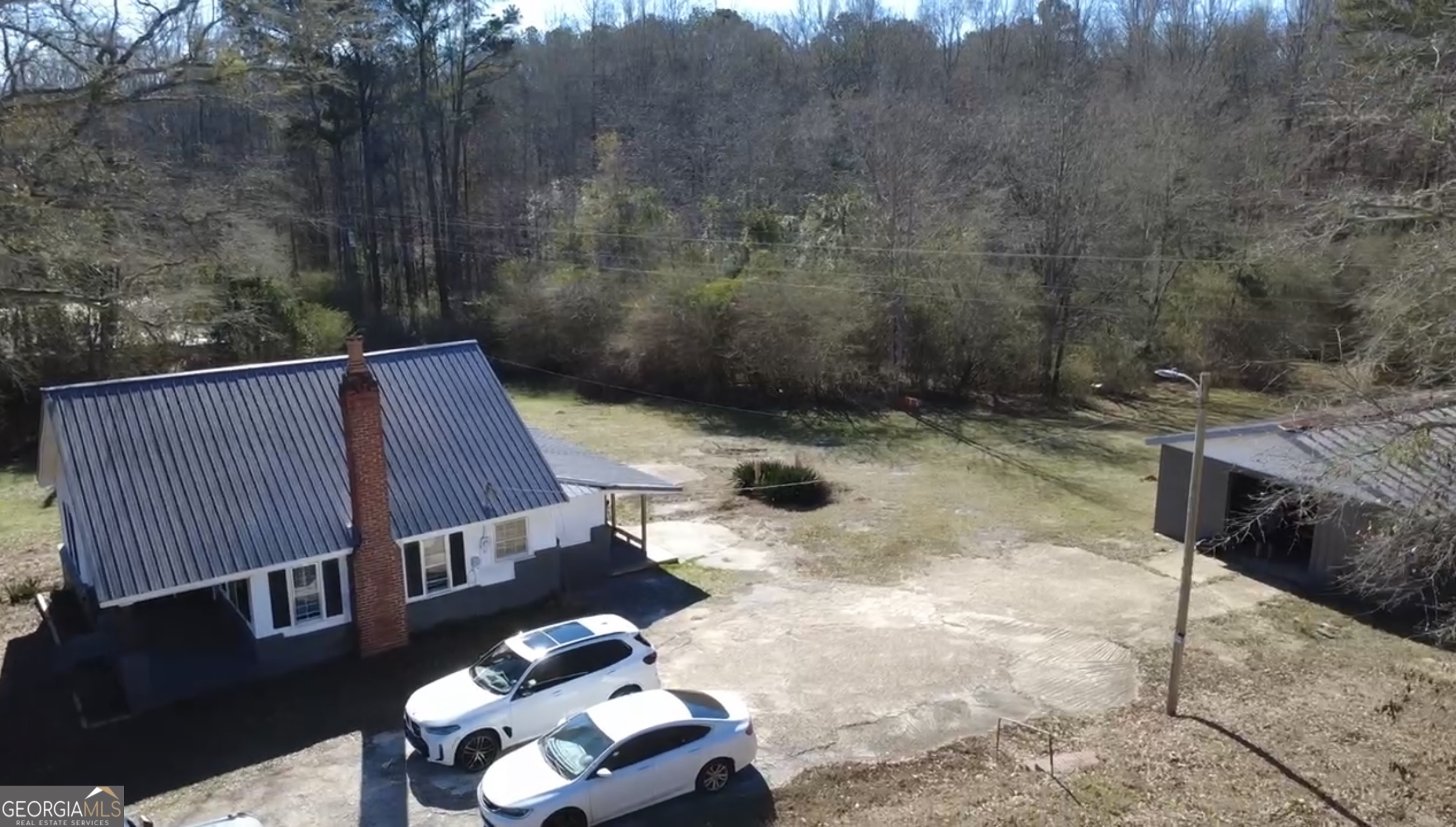 2936 Whitesville Road LaGrange, GA 30240 - Photo 7 of 42 a backyard of a house with table and chairs
