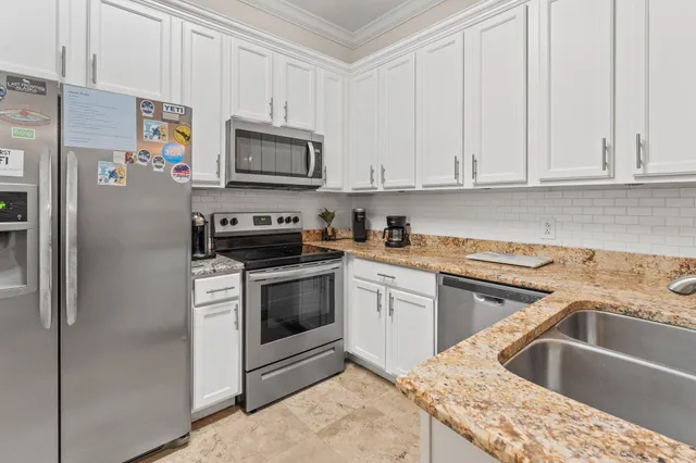 a kitchen with stainless steel appliances granite countertop a sink stove and cabinets