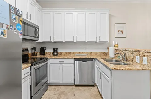 a kitchen with cabinets a sink and stainless steel appliances
