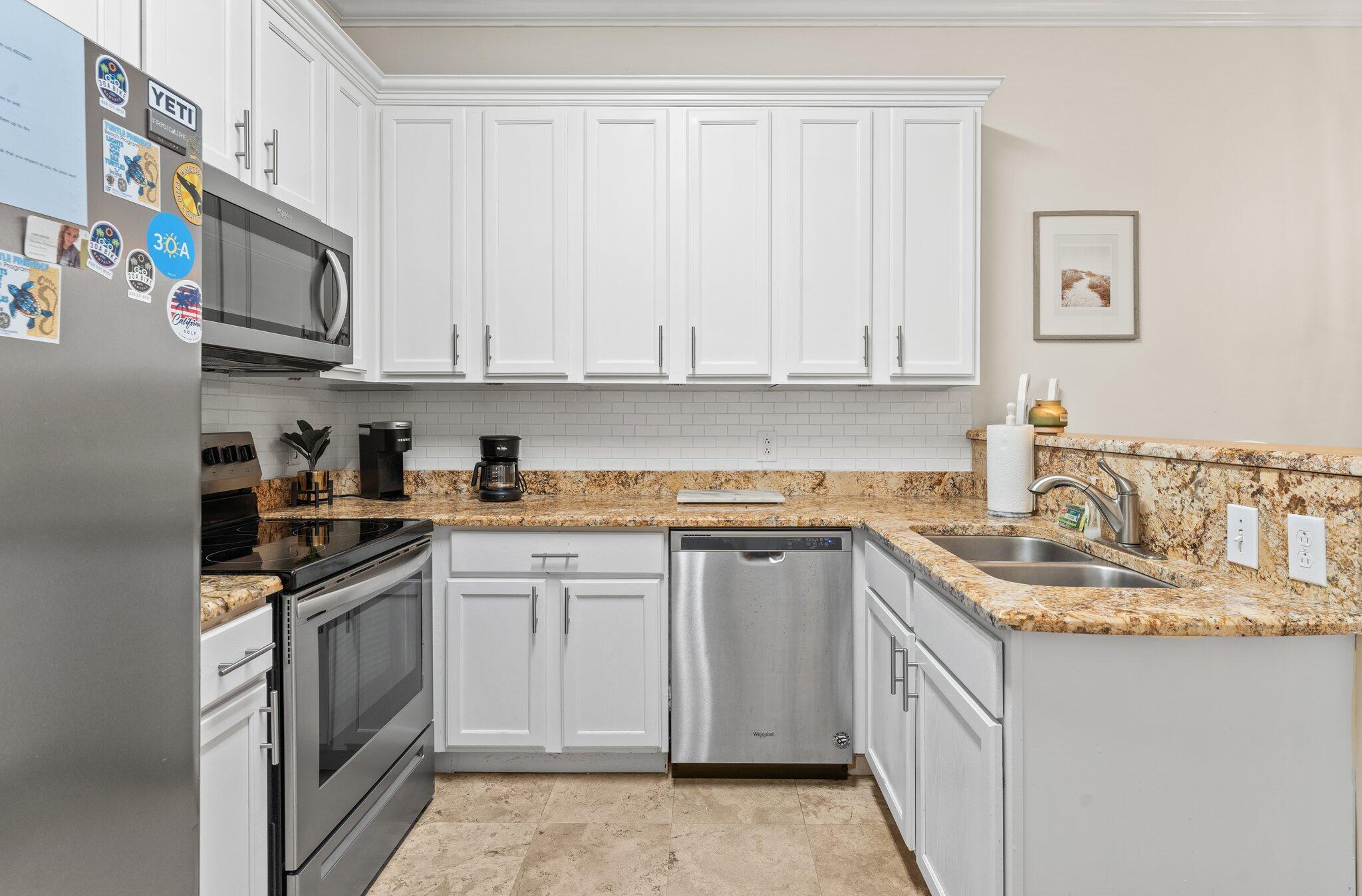 231 Somerset Bridge Road, Unit 1110 Santa Rosa Beach, FL 32459 - Photo 12 of 51 a kitchen with stainless steel appliances granite countertop a sink stove and cabinets