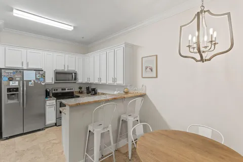 a view of kitchen appliances and cabinets